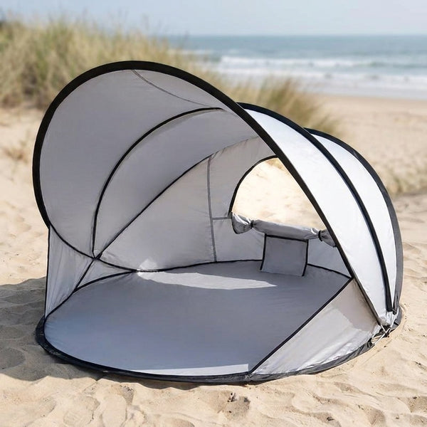 pop up beach tent open on sand as a sun shade shelter