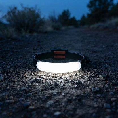 Wide beam headlamp lighting a gravel trail at dusk