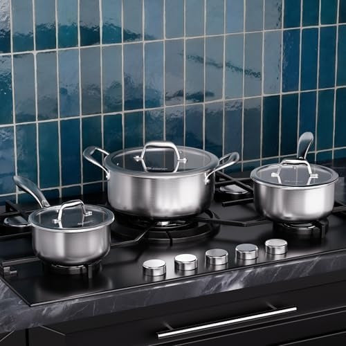 three stainless steel pots with lids cooking on a hob