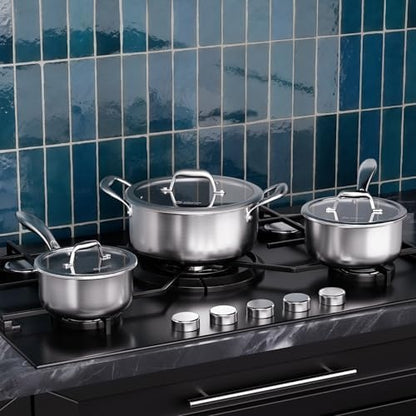 three stainless steel pots with lids cooking on a hob