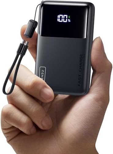 Mini power bank held in one hand to show its size
