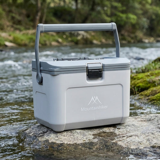 16L insulated ice box closed on a rock at the water's edge