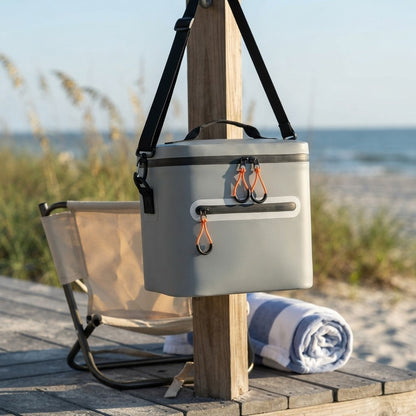 Insulated lunch cooler hanging by its shoulder strap at the beach