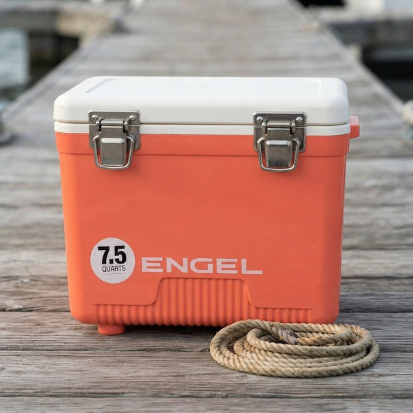 Drybox cooler closed on wooden dock boards beside a coil of rope