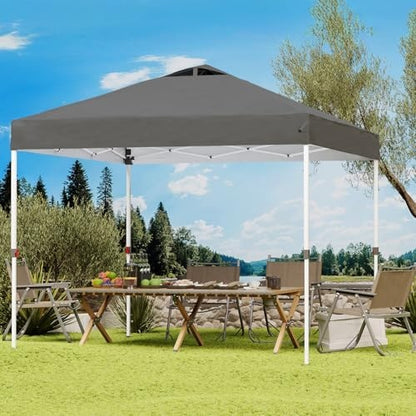 pop up canopy shading an outdoor table beside a lake