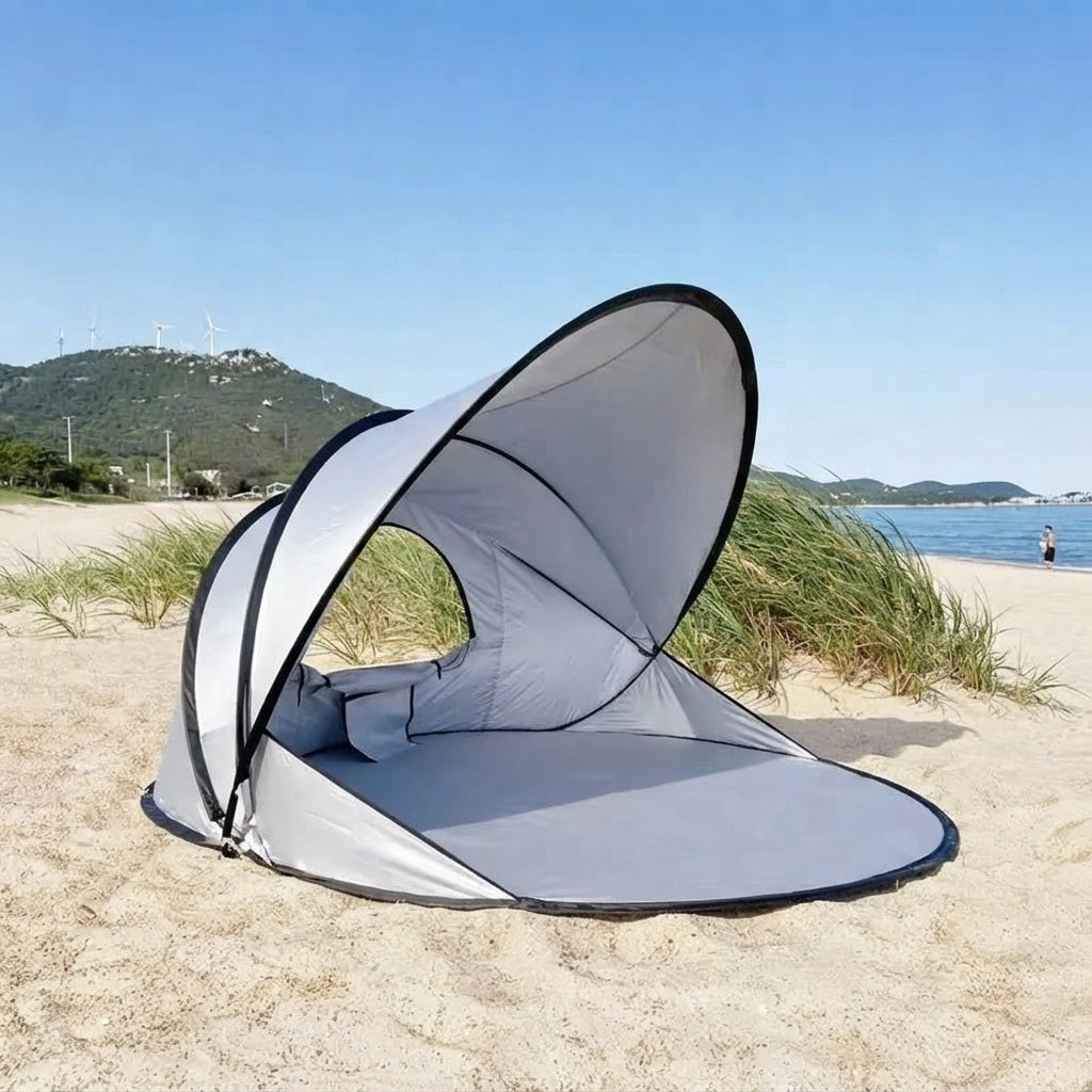 pop up sun shade shelter seen from the side on a breezy beach