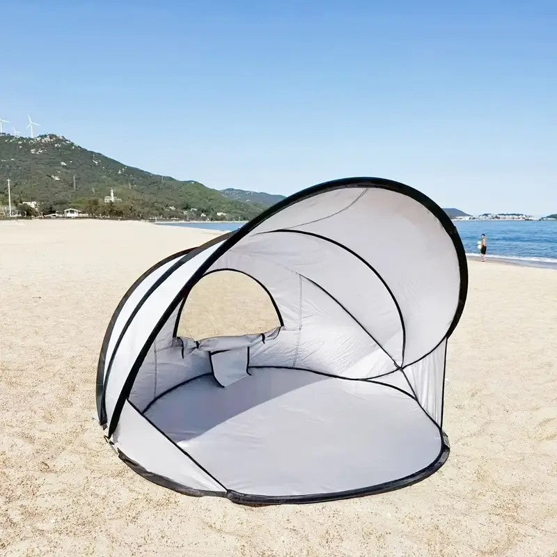 beach tents and canopies pitched on a beach beside the sea