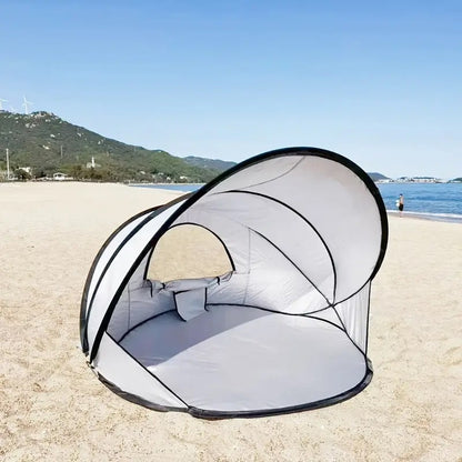 beach tents and canopies pitched on a beach beside the sea
