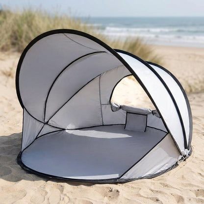 pop up beach tent open on sand as a sun shade shelter